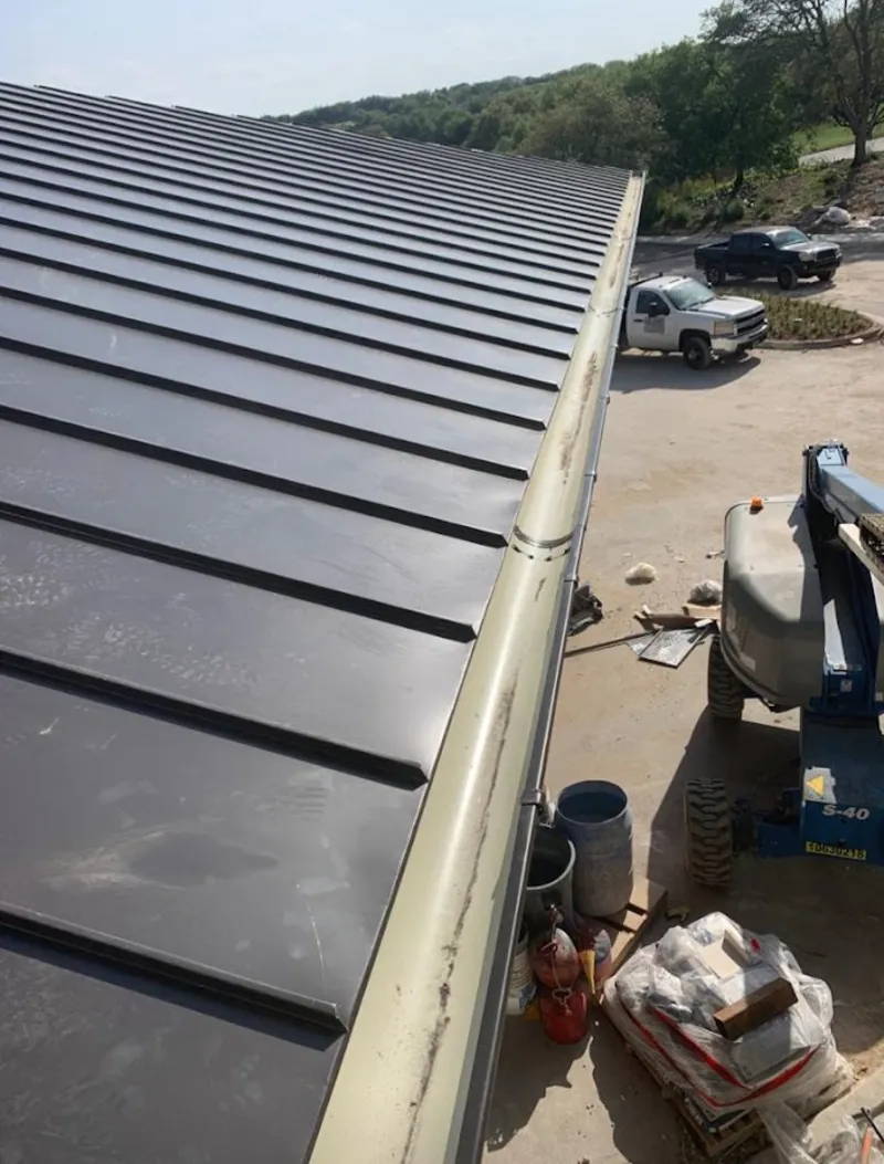 Standing seam panel and gutter detail on a metal roofing jobsite in Elmwood Park